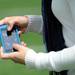 Using an iPhone, Julie Foguenne, of Parrot in Southfield, operates a second generation augmented reality drone around the field during Michigan Robotics Day at the Jack Roth Stadium Club at Michigan Stadium on Monday, April 15, 2013. Melanie Maxwell I AnnArbor.com